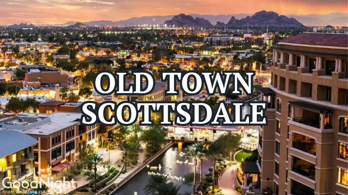 A vibrant cityscape featuring Scottsdale's skyline, with mountains in the background and illuminated water features at the forefront. The scene is lively, with illuminated buildings and hints of people enjoying the area at dusk, evoking the energy of Old Town Scottsdale's nightlife, dining, and shopping.